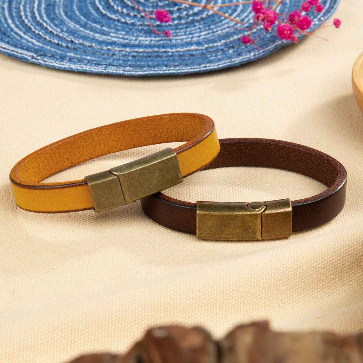 ring, Colorful personalized bracelet display with yellow and brown leather on beige surface