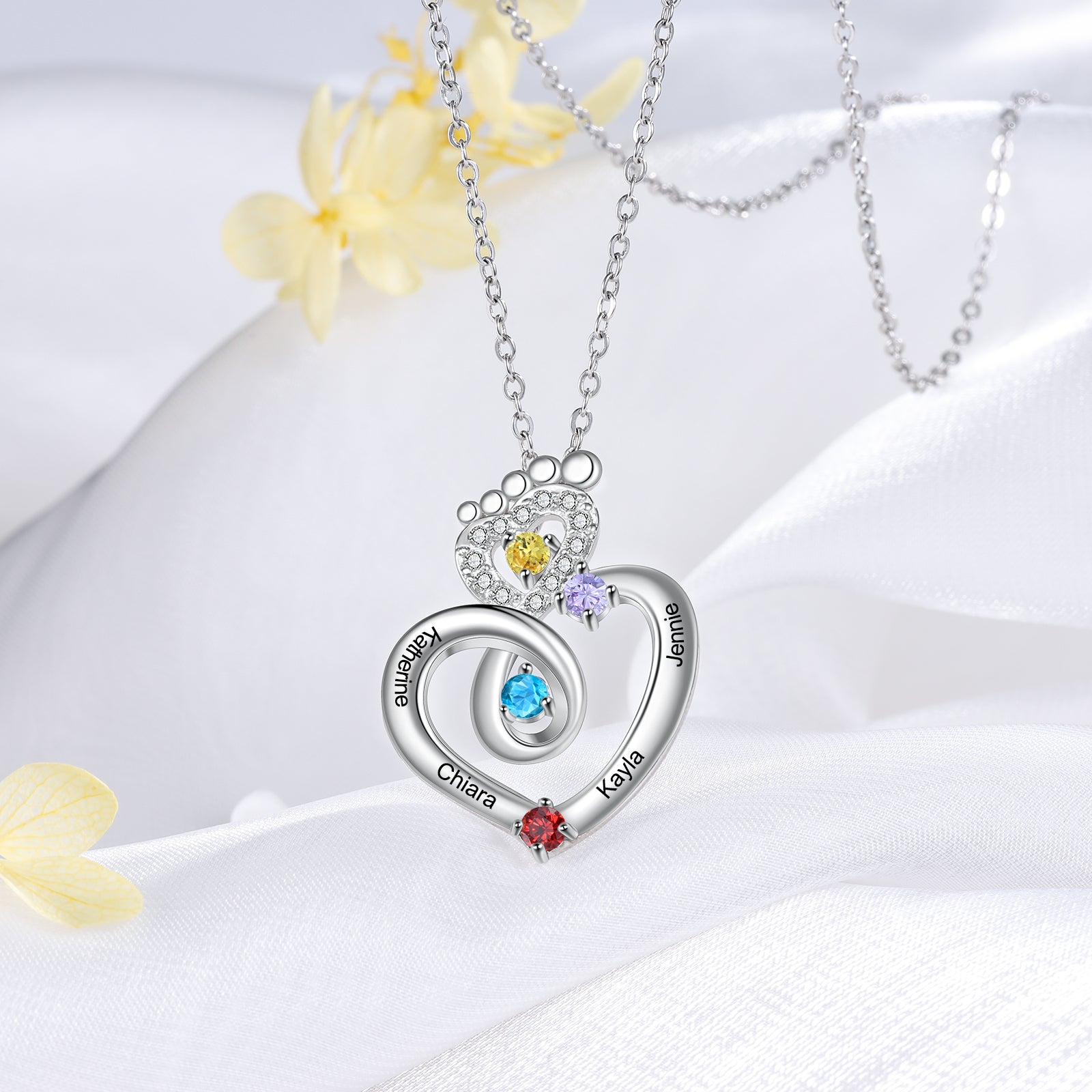 jewelry earrings, Silver heart necklace with multicolored gemstones and engraved names on white fabric