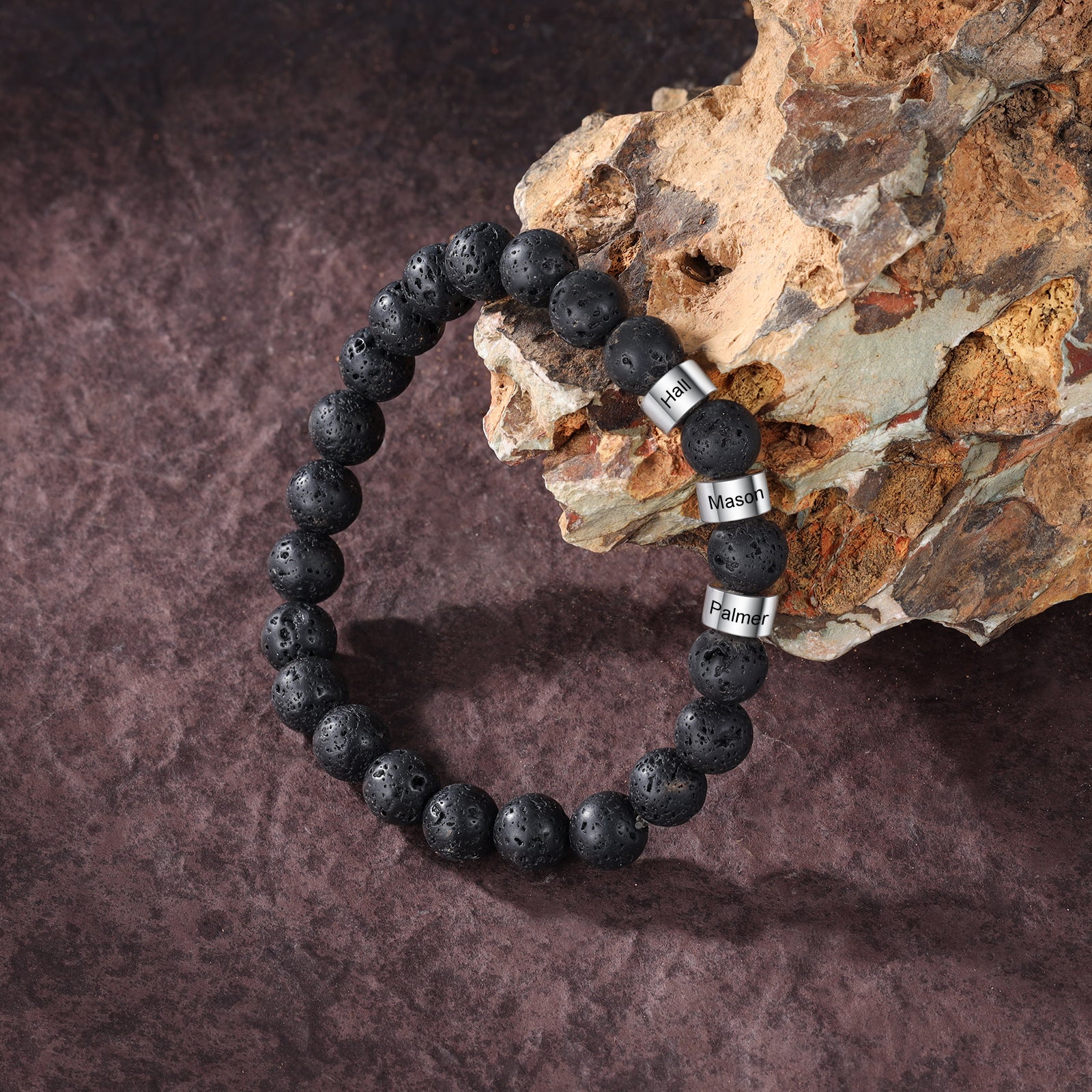 birthstone keychain, Personalized bracelet with silver "Hail" and "Palmer" charms on natural surface