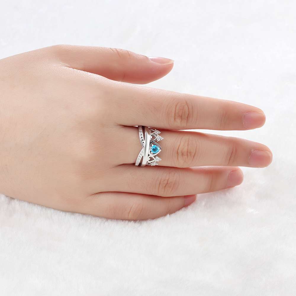 hand wearing Custom 925 Sterling Silver Crown Ring with blue gemstone, elegant and sophisticated