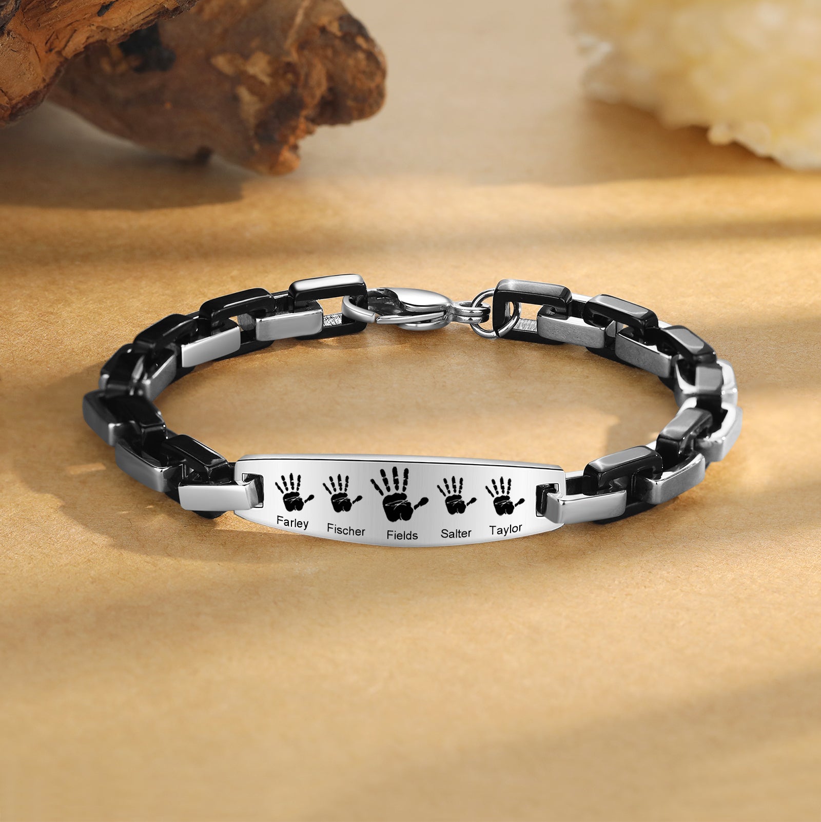 earrings with names, Personalized Bracelet on beige surface with handprints and names: Farley, Fischer, Felix.