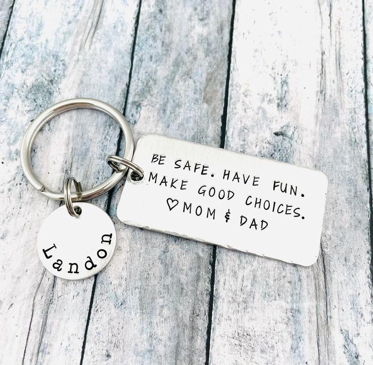 Custom family keychain with "Landon" tag on wooden surface