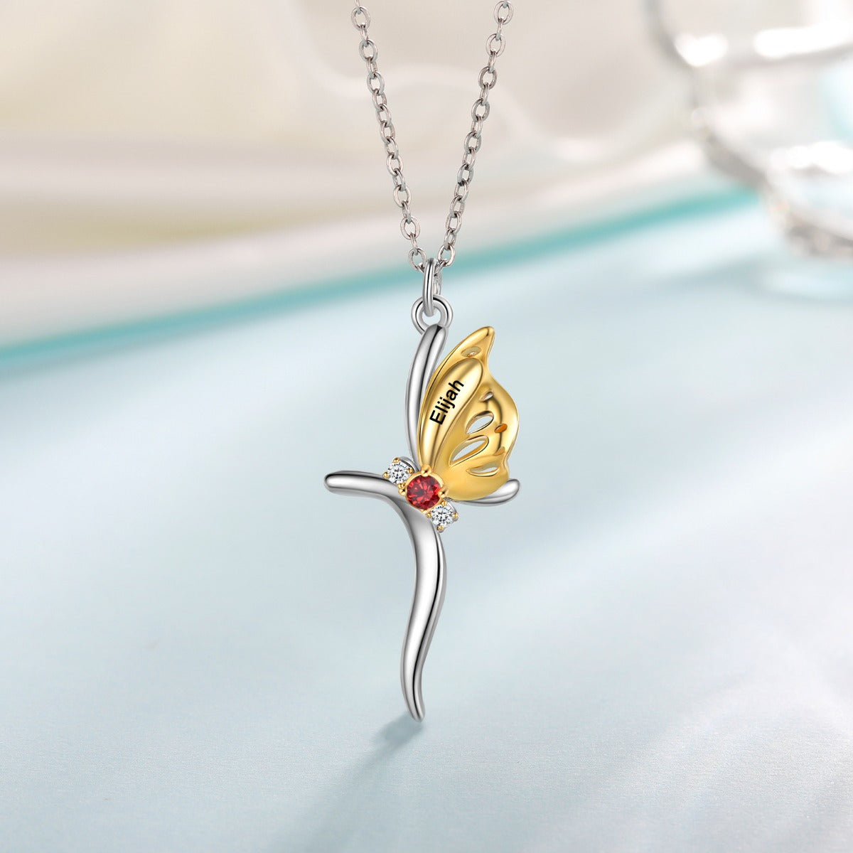 keychains, Butterfly Necklace with gold butterfly on silver cross, engraved "Elijah" on silver chain.