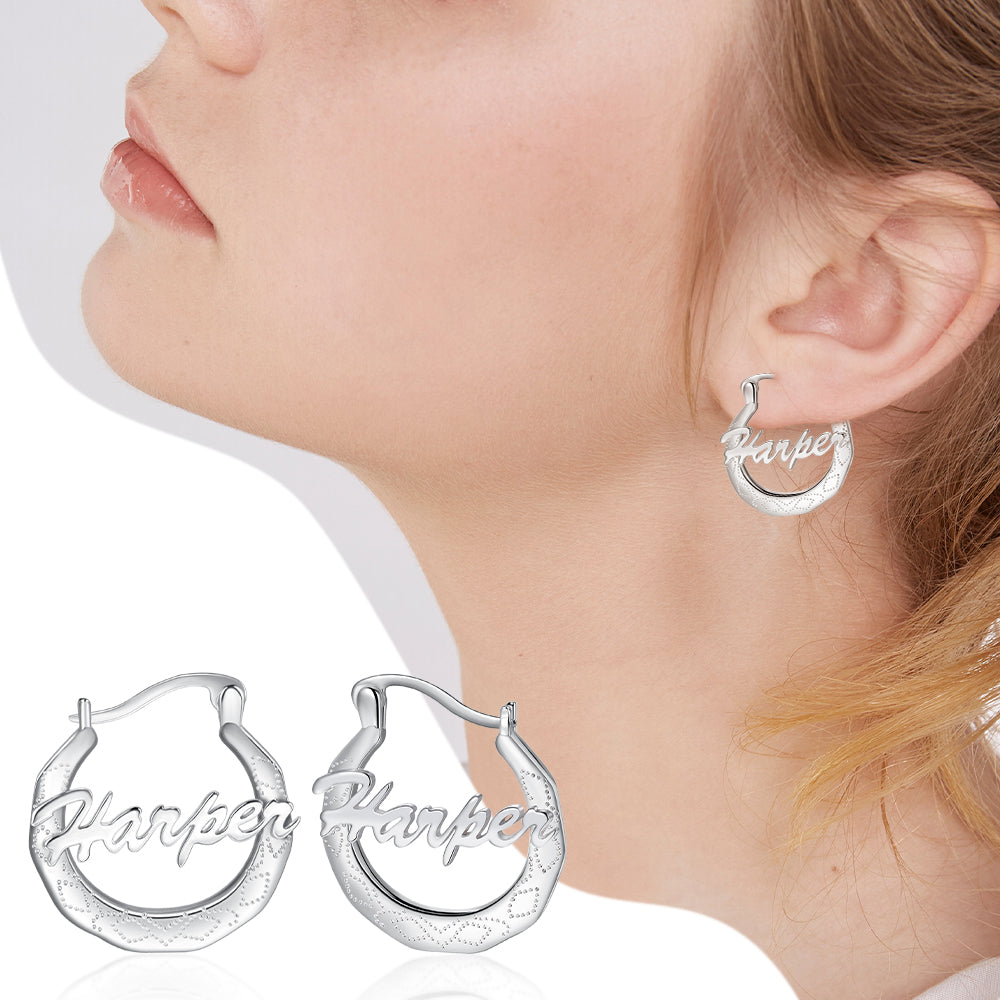 jewelry earrings, Silver earrings inscribed with "Harper" and worn on a person's profile.