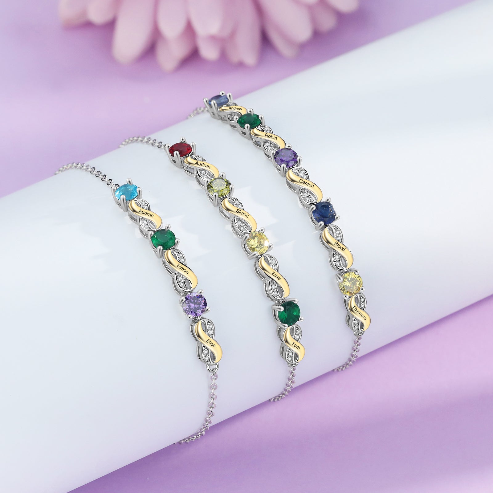 Custom Birthstone Bracelet trio on a pink backdrop; vibrant Birthstone Jewelry display.