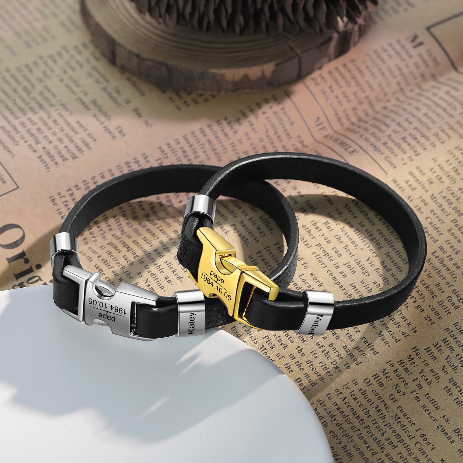 necklace, personalized leather bracelet with silver and gold buckles on newspaper backdrop